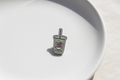 Enamel sticker of a drink with text matcha on a green cup