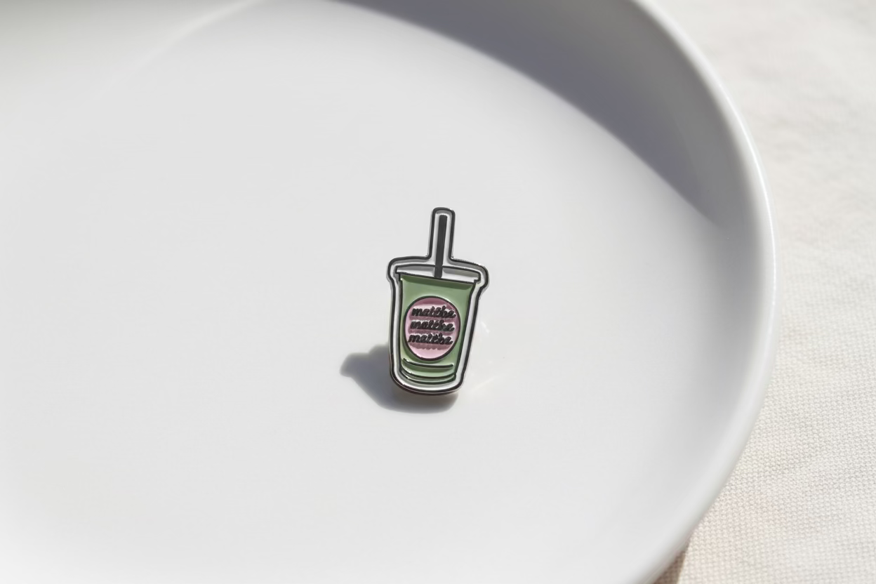 Enamel sticker of a drink with text matcha on a green cup
